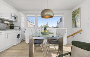 a kitchen with a table with a bowl of fruit on it at Seebär in Olpenitz