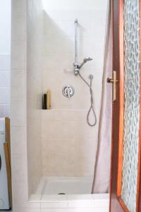 a shower in a bathroom with a shower curtain at Sanremo Apartments - Ortensia in Sanremo +15 photos