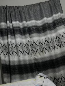 a window curtain with a black and white pattern at Kaunda Home in Blantyre