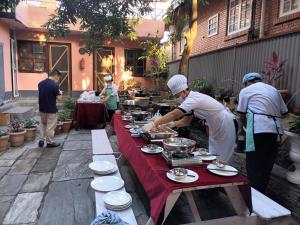 a group of people preparing food on a table at Sagarmatha Apartment Hotel in Pātan