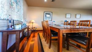 a dining room with a wooden table and chairs at Bantry Two in Merimbula