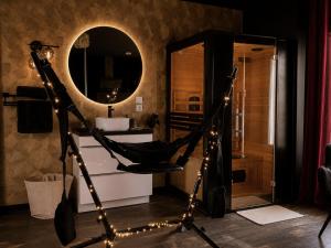 a bathroom with a hammock in front of a mirror at ღ Love Room intime - Sauna - Hmm OH Oui ღ in Saint-Quentin