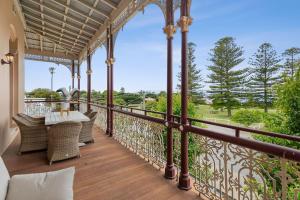 a balcony of a house with a table and chairs at Pelicans at the Ozone in Queenscliff