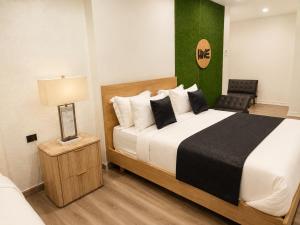 a bedroom with a large bed and a green wall at The Hive Boutique Hotel Pool Suite 108 in Scarborough +18 photos