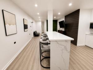 an office with a counter and a bar with stools at The Hive Boutique Hotel Pool Suite 108 in Scarborough