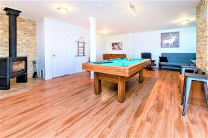 a living room with a pool table and a fireplace at Charlevoix 4BR Cottage Hot Tub & Game Room 12 in Petite-Rivière-Saint-François