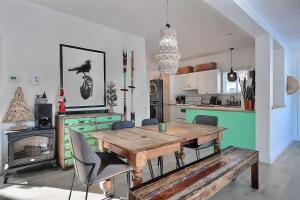 a kitchen with a wooden table and chairs in a room at Lakefront Chalet Hot Tub & Fire Pit Sleeps 6 in Saint-Raymond
