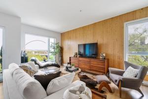a living room with a couch and chairs and a tv at 3CHParkingGymRooftop97 Walkscore10mins QC in Quebec City +28 photos