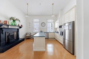 a large kitchen with a refrigerator and a stove at QPO Queenscliff in Queenscliff