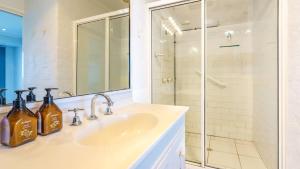 a bathroom with a sink and a shower at Quarterdeck 6 in Tura Beach +8 photos