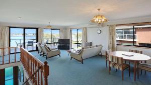 a living room with a couch and a table at SeaLeka 6 in Merimbula