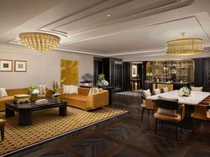a living room with a couch and a table at Fairmont Mumbai in Mumbai