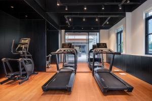 a gym with several treadmills in a room at Novotel Living Hangzhou International Convention Center in Hangzhou