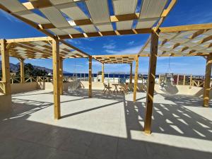 a wooden pavilion with a view of the beach at Isis Dahab in Dahab