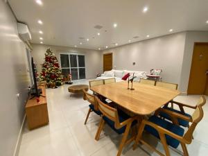 a living room with a table and a christmas tree at Lara Country House in Guarulhos