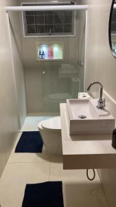 a white bathroom with a sink and a toilet at Lara Country House in Guarulhos +19 photos