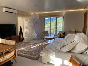 a bedroom with a large bed and a large window at Lara Country House in Guarulhos