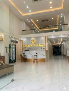 a lobby of a hotel with a happy hour sign on the wall at Glory Hotel in Can Tho