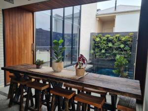 a wooden table with chairs and plants on a patio at Stella on Stevens in Queenscliff