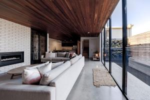 a living room with a couch and a fireplace at Stella on Stevens in Queenscliff