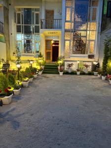 a building with a courtyard with potted plants and lights at Serenity Inn home stay in Srinagar +30 photos