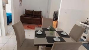 a dining table and chairs in a living room at Apto 5 pessoas - Prox FIP e Stop Shop in Brusque