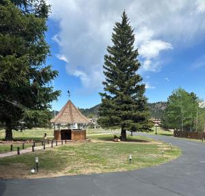 a tree and a gazebo in a park at Columbine Inn in Estes Park