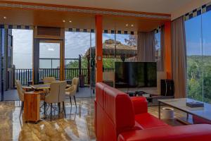a living room with a red couch and a television at Guilin Thai Impression in Gukeng