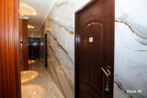 a bathroom with a wooden door and a corridor at Lestari Malioboro Guesthouse in Sentool +44 photos