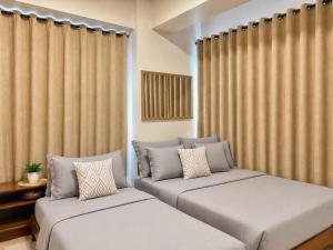 two beds in a room with curtains at Spacious 2beds 1bedroom in Punta Engaño +30 photos