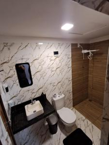 a bathroom with a toilet and a sink and a shower at Conexão Cariri in Juazeiro do Norte +20 photos