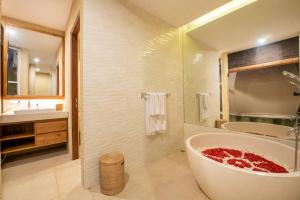 a bathroom with a large tub and a sink at Triyana Resort and Glamping Carangsari Bali in Payangan +11 photos