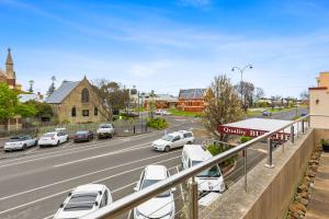 a parking lot with cars parked on a street at The Scoop in Queenscliff +8 photos