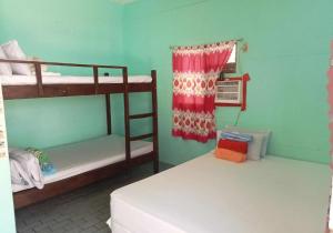 a room with two bunk beds and a window at Mannor Beach Resort by Hiverooms in Carmen