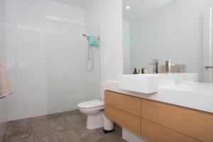 a bathroom with a sink and a toilet and a shower at Margaret House | Elegant City-Fringe Escape in North Adelaide
