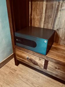 a dvd player sitting in a wooden drawer at Home Dejavu in Gili Trawangan