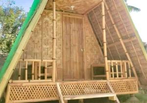 a house with a hammock in front of it at Mannor Beach Resort by Hiverooms in Carmen