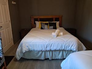 a bed with a teddy bear sitting on it at El Laurel in Chillán +2 photos