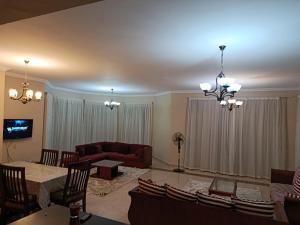 a living room with a couch and a table at Stand alone Villa at Blumar North coast -SIDI ABD ALRAHMAN in El Alamein +72 photos