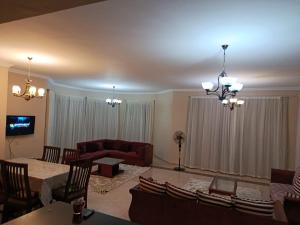 a living room with a couch and a table at Stand alone Villa at Blumar North coast -SIDI ABD ALRAHMAN in El Alamein