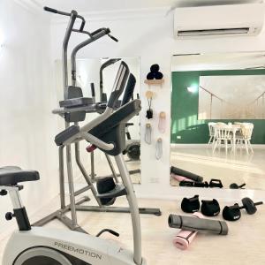 a room with a gym with a treadmill at Luxury 2 Bedroom apartment, Treetop views, Resort with 4 swimming pools in Cairns North +41 photos