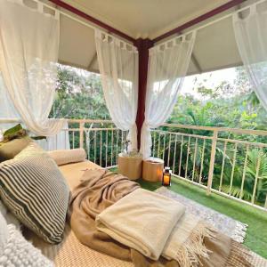 two beds in a room with a balcony at Luxury 2 Bedroom apartment, Treetop views, Resort with 4 swimming pools in Cairns North