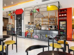 a restaurant with tables and chairs and a counter at ibis Styles Old Tbilisi in Tbilisi City