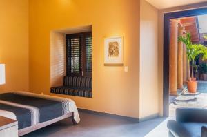a bedroom with a bed and a window at Red Tree Oaxaca in Oaxaca City +46 photos