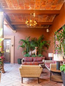 a lobby with a couch and a statue of a deer on the wall at Red Tree Oaxaca in Oaxaca City