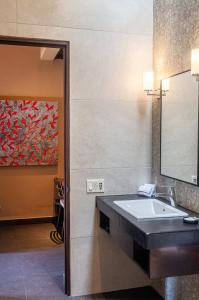 a bathroom with a sink and a painting on the wall at Red Tree Oaxaca in Oaxaca City