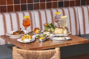 a table with plates of food and drinks on it at Peppers Soul Surfers Paradise in Gold Coast