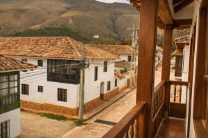 a view from a balcony of a town with mountains at Yeshca Hotel Boutique in Villa de Leyva +22 photos