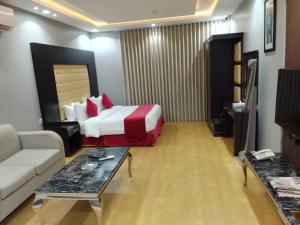 a hotel room with a bed and a couch at راحتي هنا in Riyadh