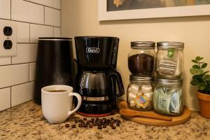 a coffee maker and a cup of coffee on a counter at King Bed Sleeps 3 2 Beds Walkable Cozy in Philadelphia